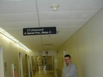 Terry Wilfong wheels the boxed remains of the mummified child down a hallway on a stretcher in a hospital.